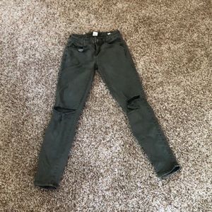 A pair of dark olive green jeans